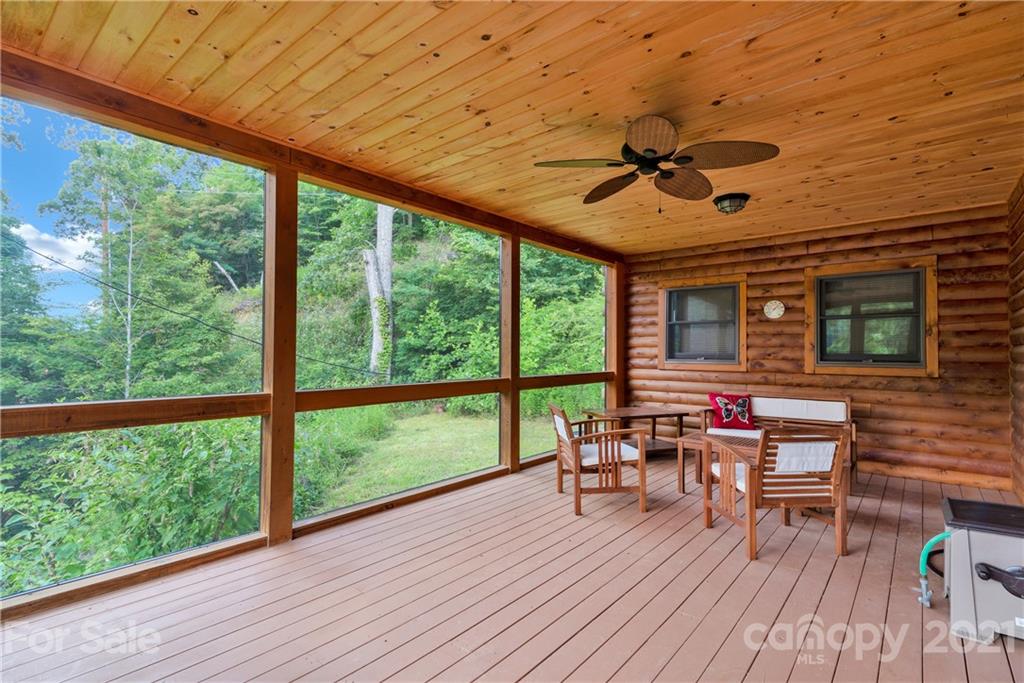210 Angel Falls Road Clyde, NC 28721 - Photo 11 of 40 a balcony with furniture and wooden floor