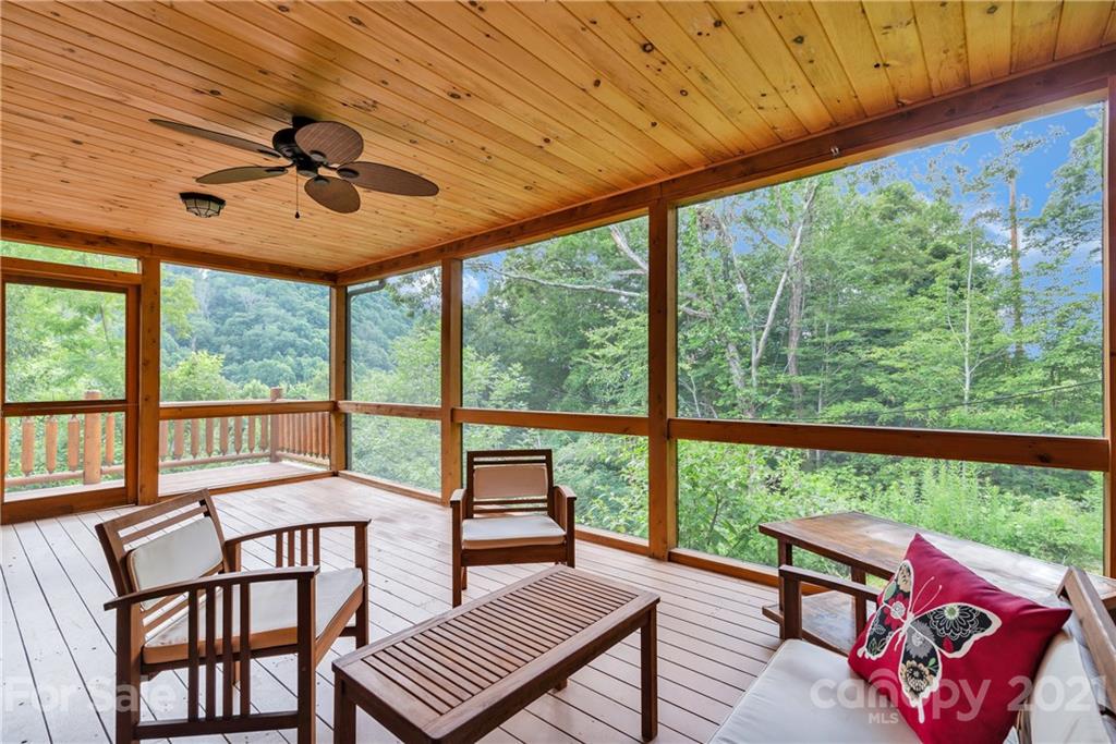 210 Angel Falls Road Clyde, NC 28721 - Photo 12 of 40 a view of a patio with a table chairs and a backyard