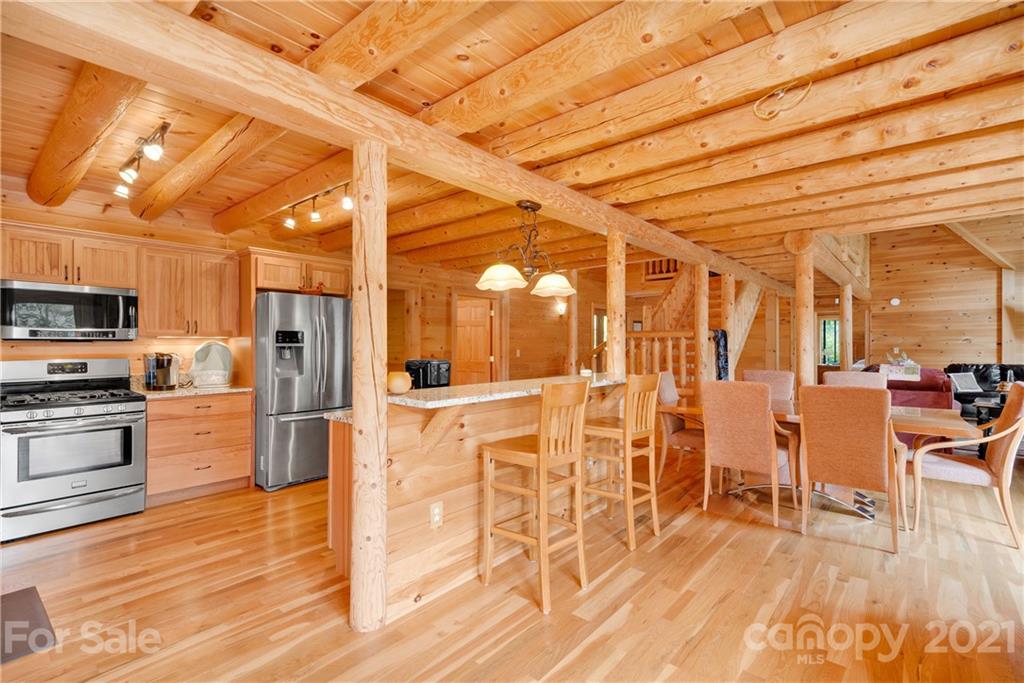 210 Angel Falls Road Clyde, NC 28721 - Photo 15 of 40 a kitchen with stainless steel appliances a refrigerator and chairs