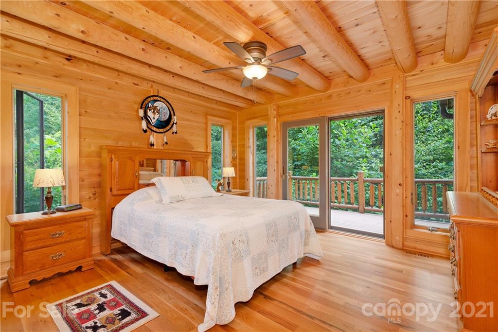 210 Angel Falls Road Clyde, NC 28721 - Photo 20 of 40 a bedroom with a large bed and a large window