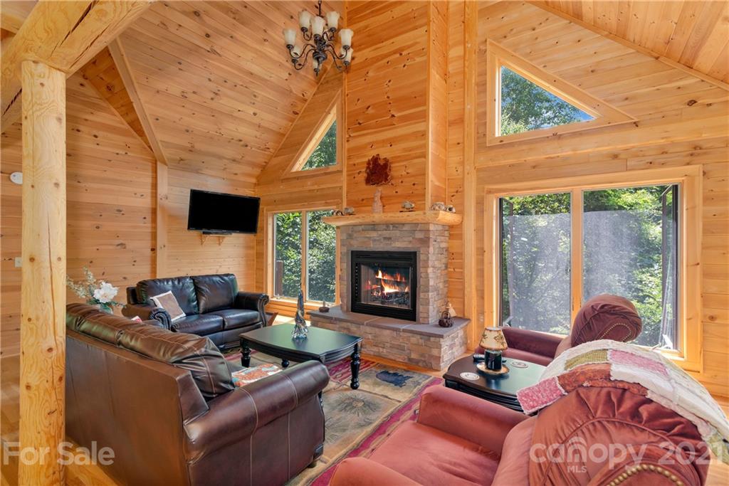 210 Angel Falls Road Clyde, NC 28721 - Photo 6 of 40 a living room with furniture and a fireplace