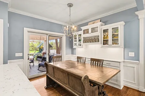 a living room with furniture two window and a dining table