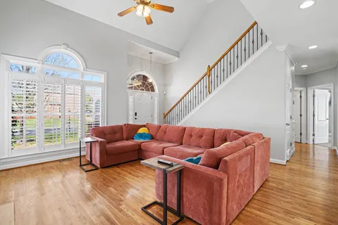 a living room with furniture and wooden floor