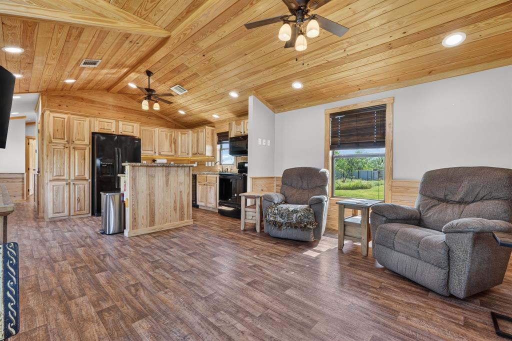 2401 Lamkin Road Mineral Wells, TX 76067 - Photo 7 of 36 a living room with furniture and kitchen view