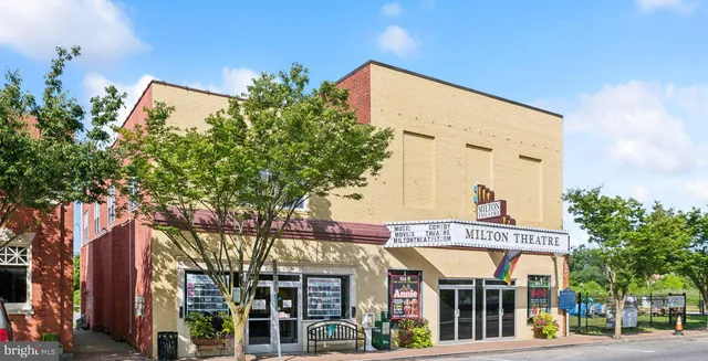 front view of a building with a tree