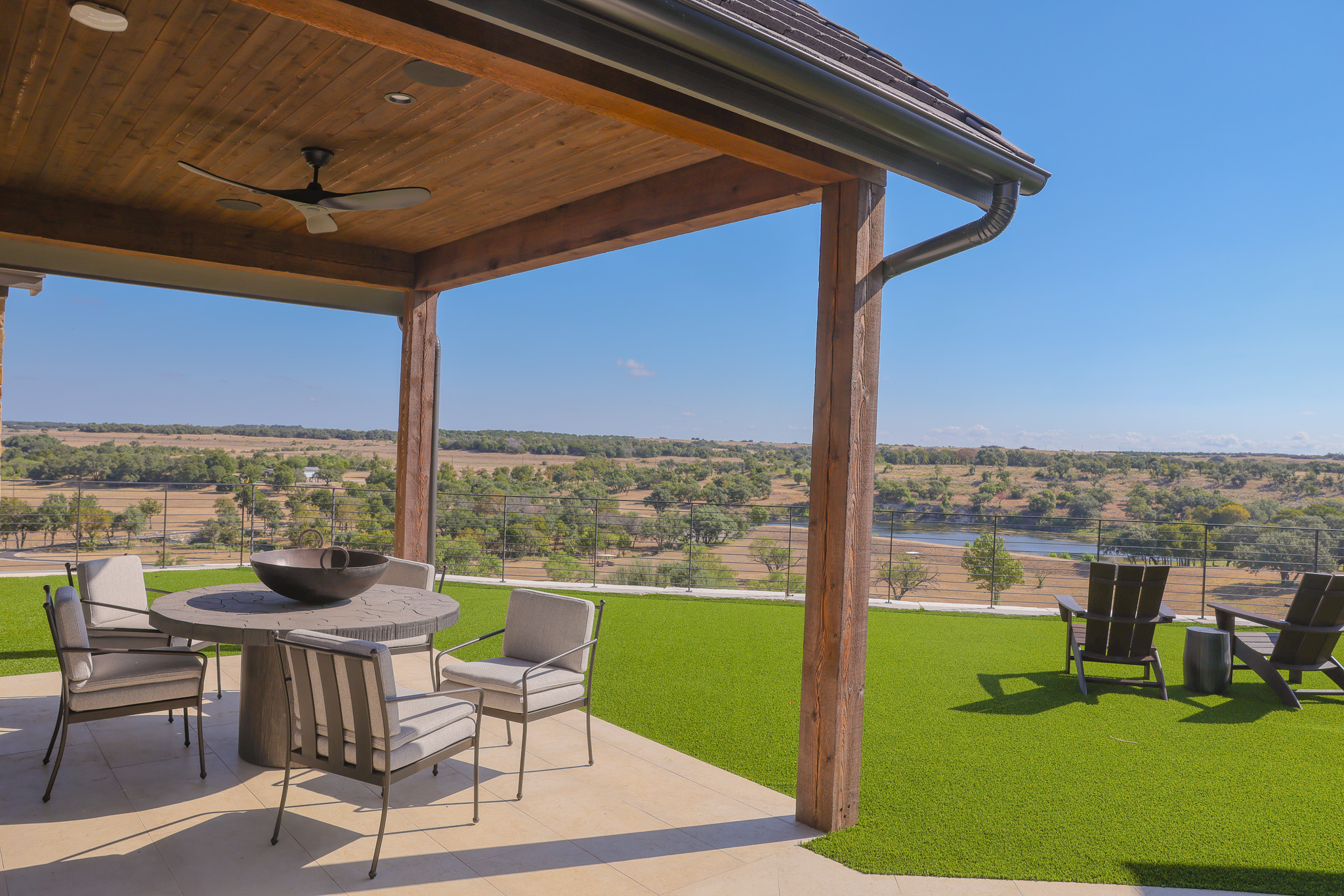 920 Ryan Road Bertram, TX 78605 - Photo 32 of 40 A covered patio with wood-paneled ceilings opens to sweeping country and water views.