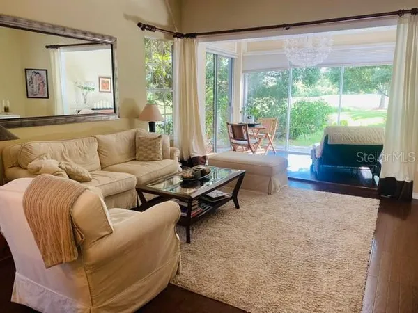 a living room with furniture and a large window