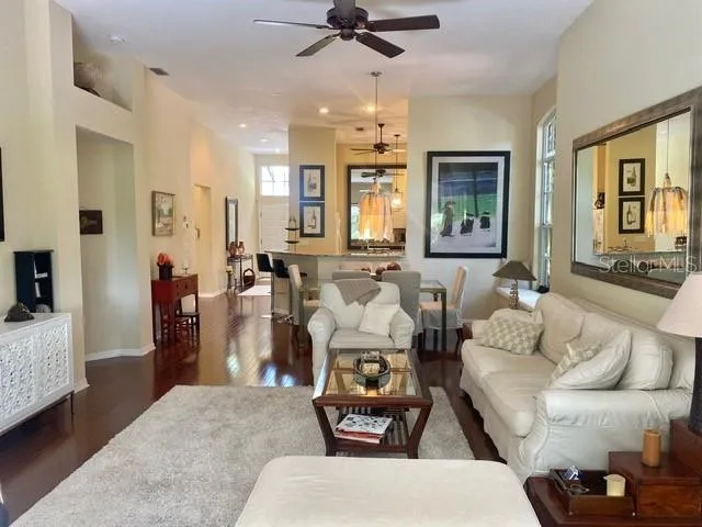 a living room with furniture and a chandelier
