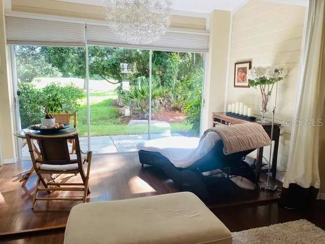 a living room with furniture and a floor to ceiling window