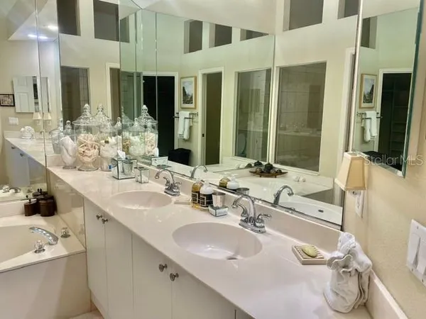 a bathroom with a double vanity sink and a mirror