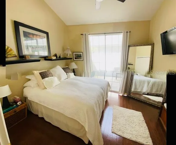 a bedroom with a bed and wooden floor