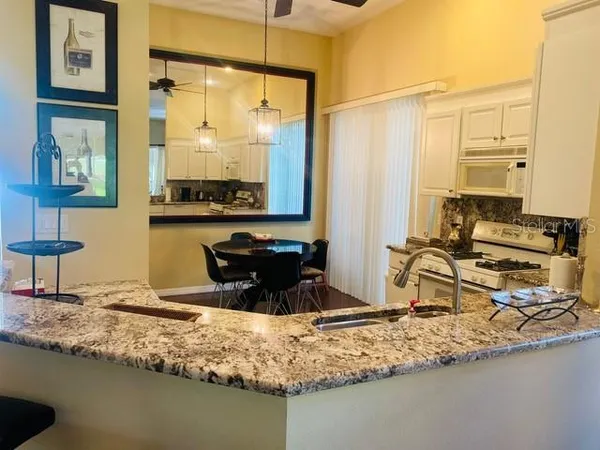 a kitchen with sink a window and couch