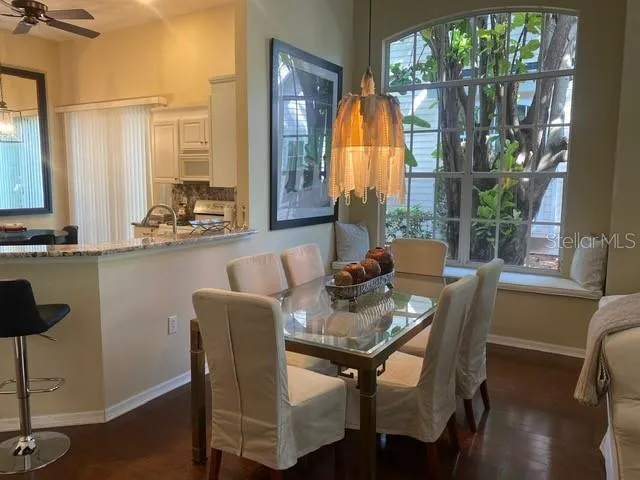 a dining room with furniture a chandelier and wooden floor