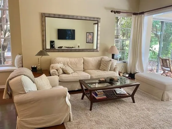 a living room with furniture and a flat screen tv