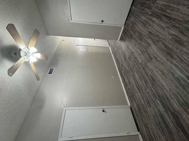 4608 Bennett Avenue, Unit 106 Austin, TX 78751 - Photo 2 of 9 an empty room with wooden floor and fan