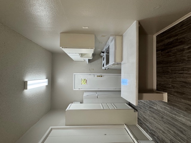 4608 Bennett Avenue, Unit 106 Austin, TX 78751 - Photo 3 of 9 a kitchen with kitchen island a sink stove and refrigerator