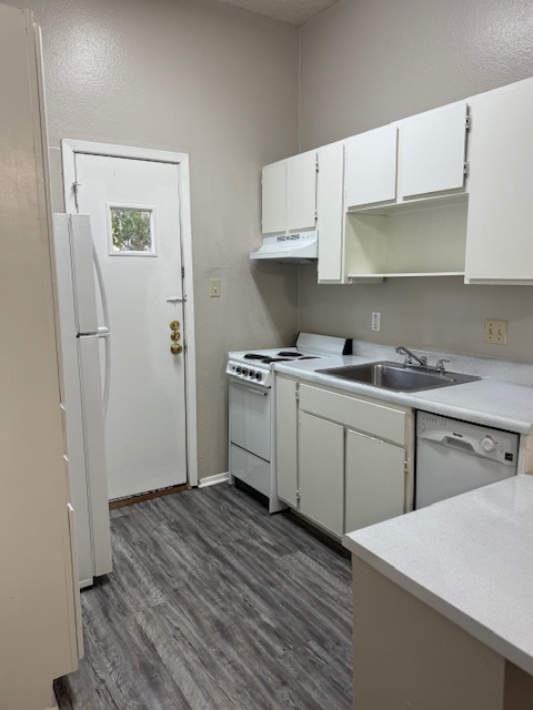 4608 Bennett Avenue, Unit 106 Austin, TX 78751 - Photo 4 of 9 a kitchen with a sink a stove and refrigerator