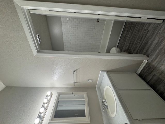 4608 Bennett Avenue, Unit 106 Austin, TX 78751 - Photo 5 of 9 a bathroom with a sink a toilet and shower