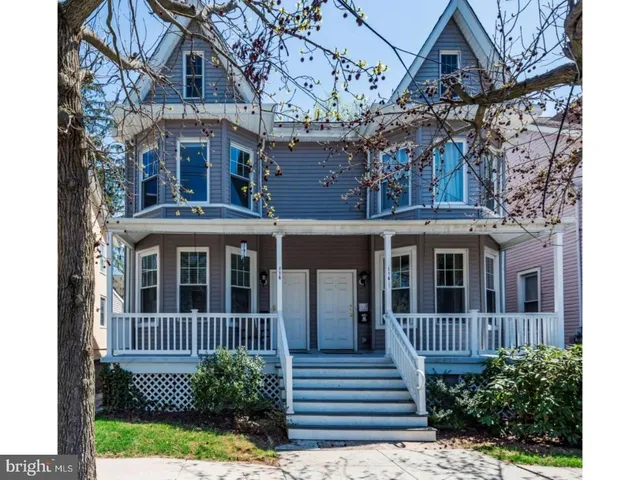 a view of a brick house with a yard