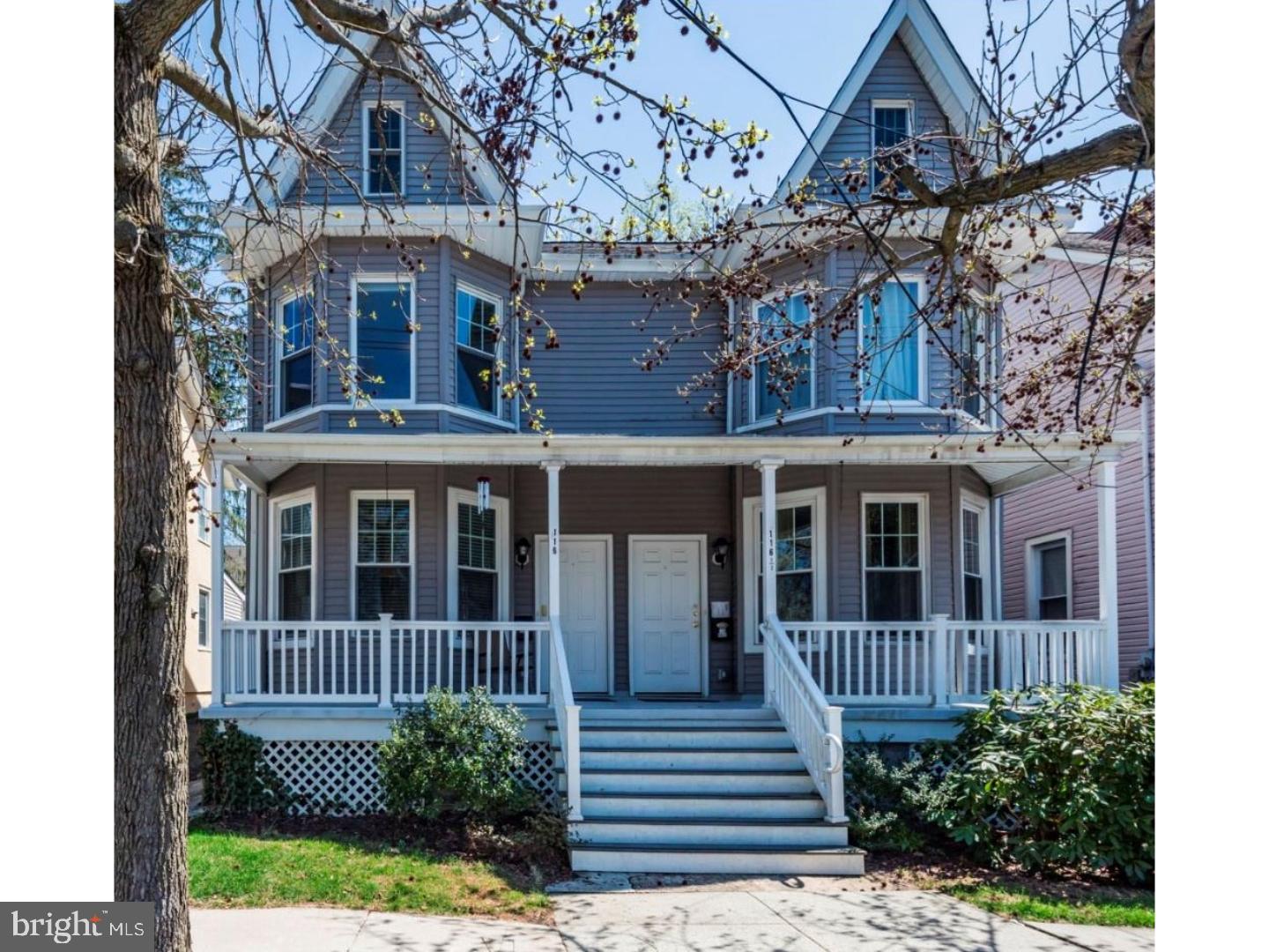 a view of a brick house with a yard