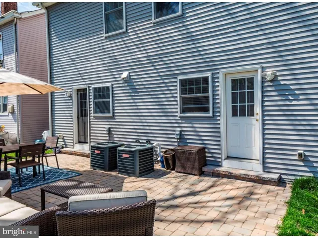 a view of patio with couches and a dining table with garden