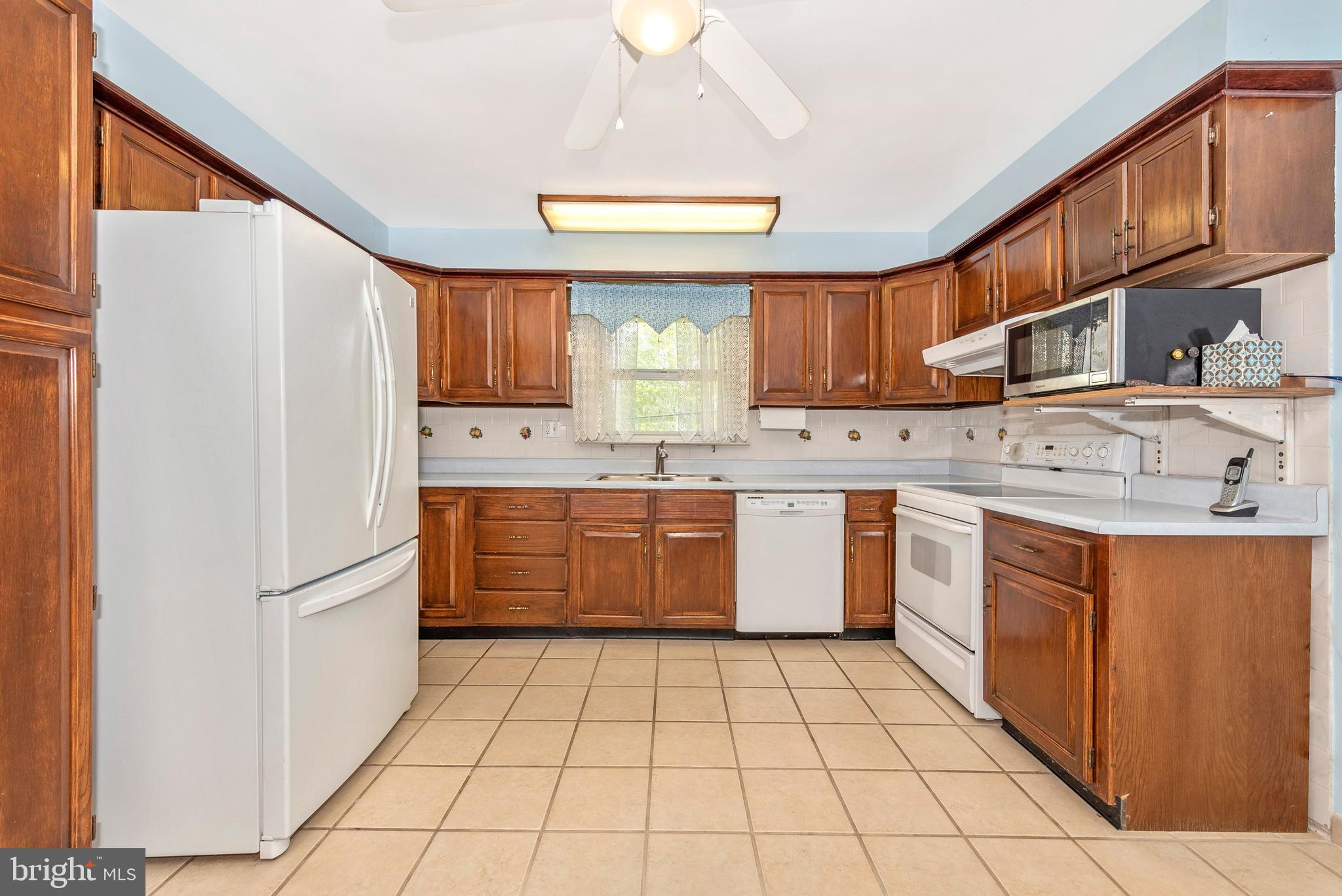 4210 Middleburg Road Union Bridge, MD 21791 - Photo 4 of 39 a kitchen with stainless steel appliances granite countertop a sink stove refrigerator and cabinets