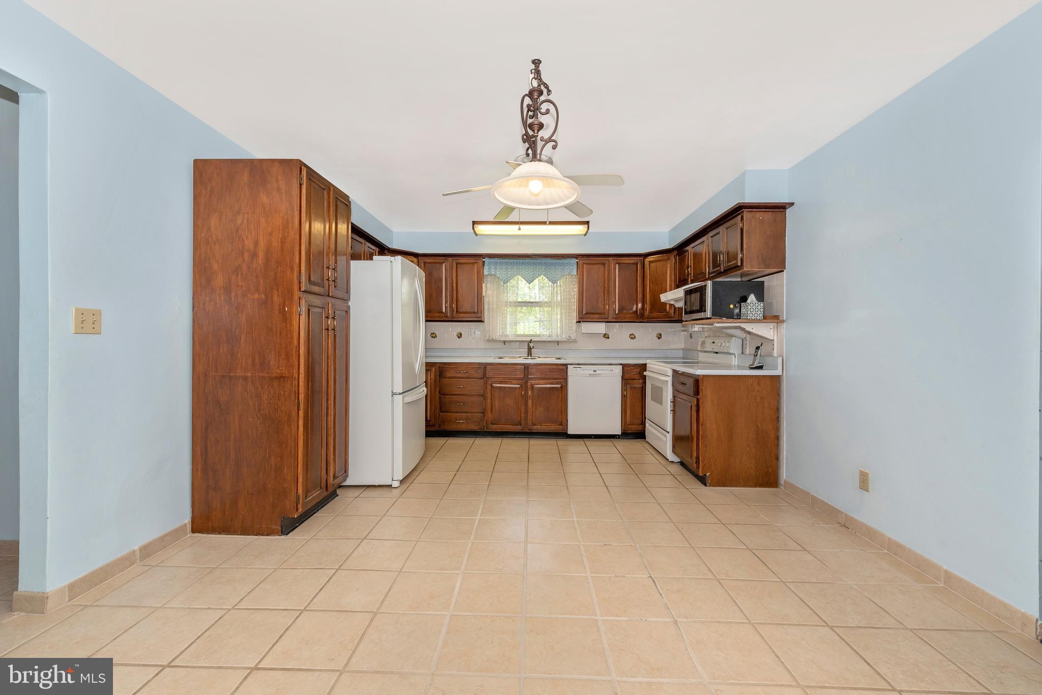 4210 Middleburg Road Union Bridge, MD 21791 - Photo 5 of 39 a view of a kitchen with a sink and a refrigerator