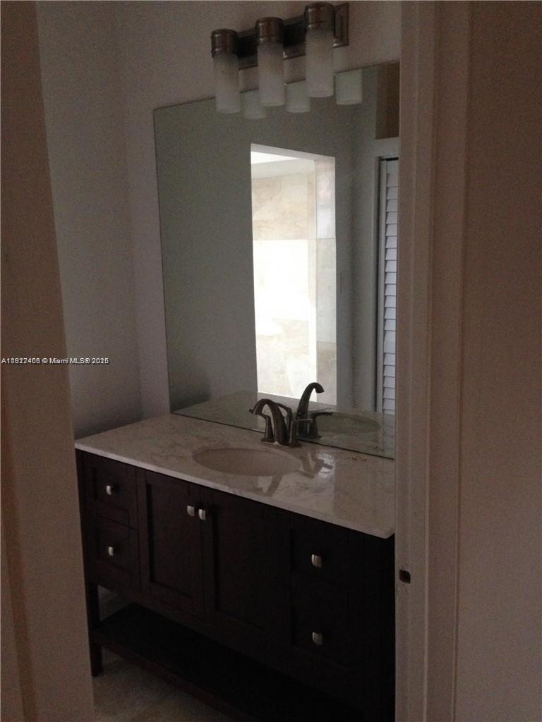 310 Southwest 34th Avenue Miami, FL 33135 - Photo 9 of 19 a bathroom with a granite countertop sink a mirror and window