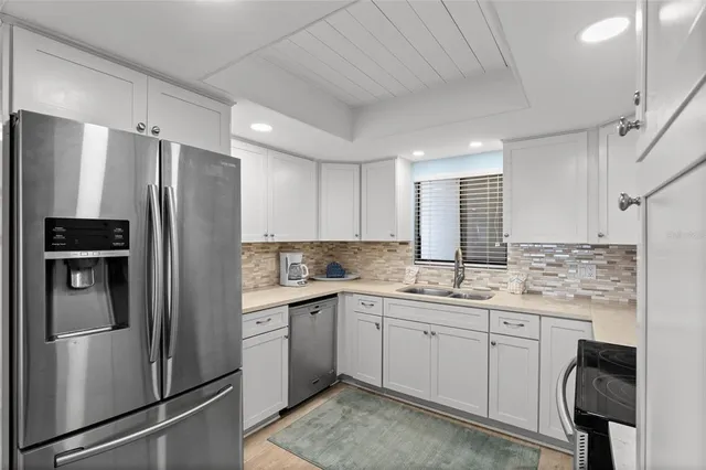 a kitchen with a sink stainless steel appliances and cabinets