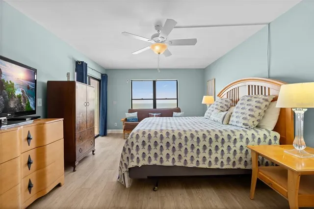 a bedroom with a bed and a flat tv screen on dresser