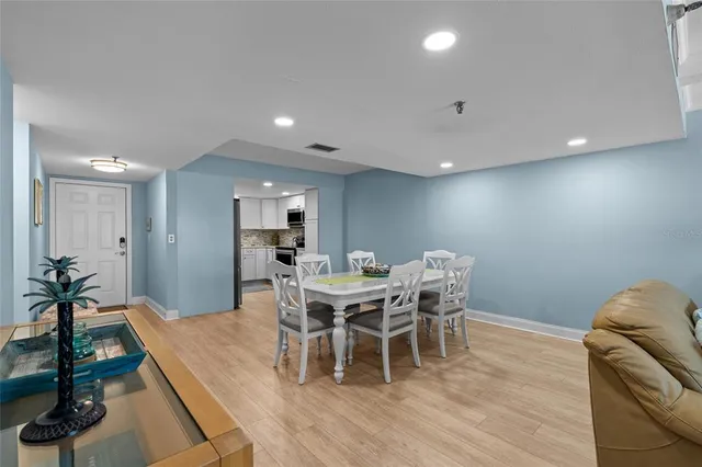 a dining room with furniture and wooden floor