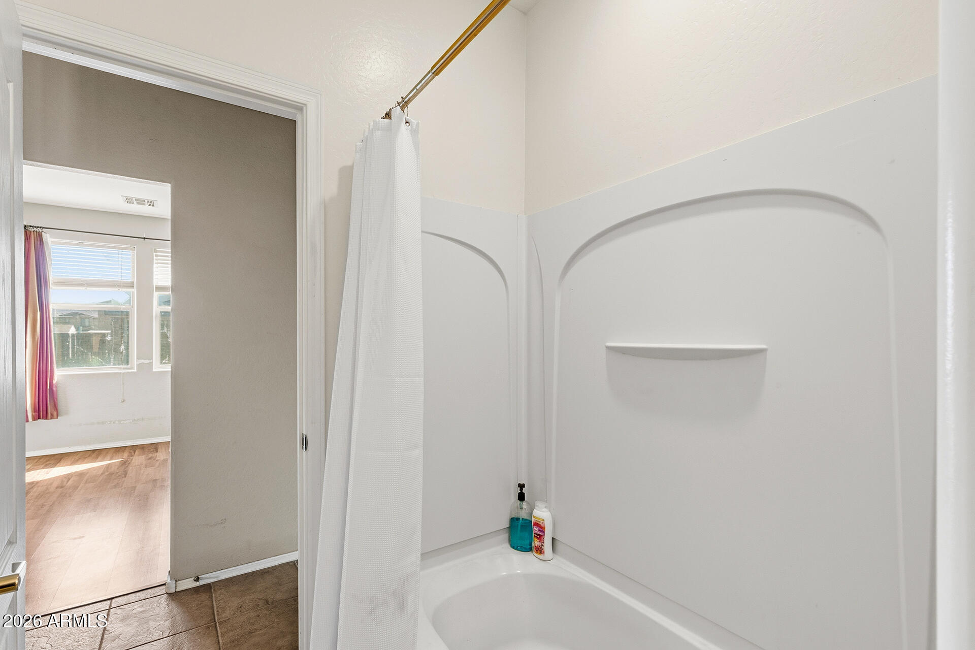 6718 West Darrel Road Laveen, AZ 85339 - Photo 22 of 49 a bathroom with a bathtub and a shower