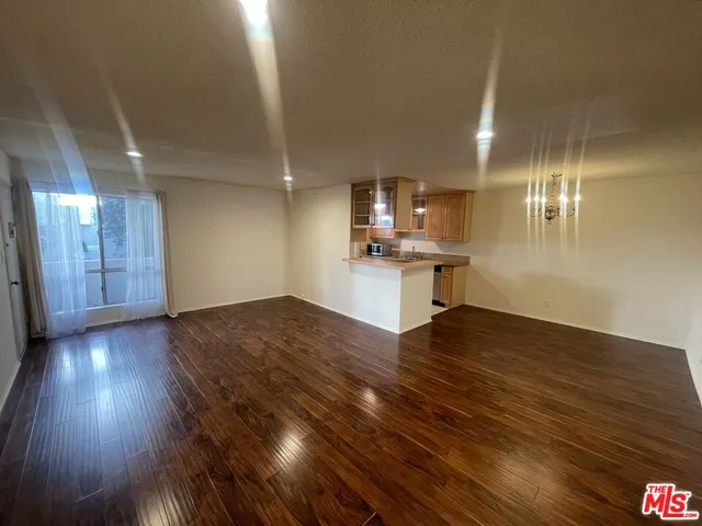 a view of a kitchen with a sink and dishwasher wooden floor