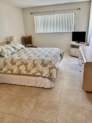 a bedroom with a bed and a chair