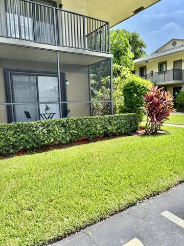 a view of a house with a garden and plants