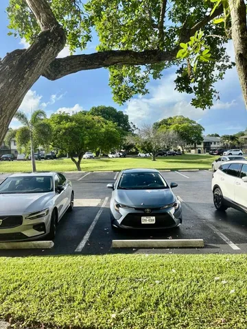 a front view of a house with a yard and fountain
