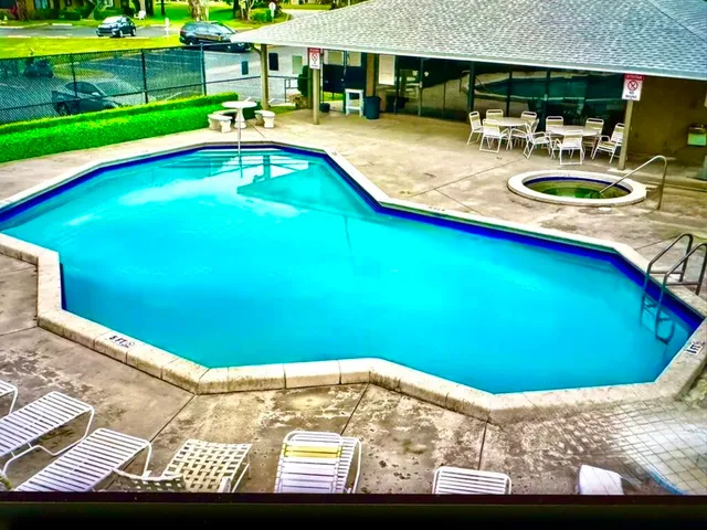 a view of a swimming pool and a yard