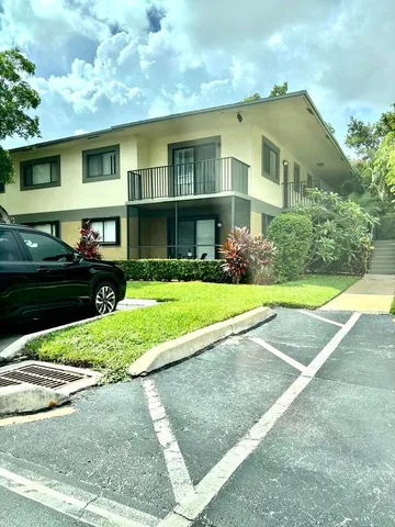 a living room with furniture and large windows