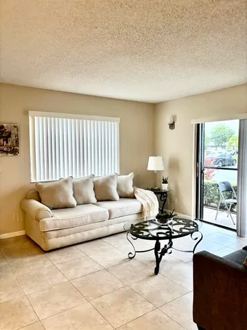 a living room with a couch and a large window