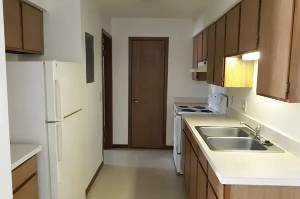 a kitchen with a sink stove and cabinets