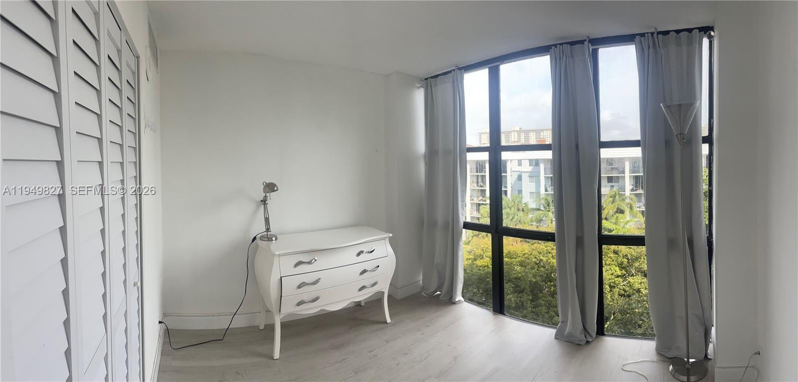 17021 North Bay Road, Unit 603 Sunny Isles Beach, FL 33160 - Photo 5 of 9 a bed room with a bed and a window