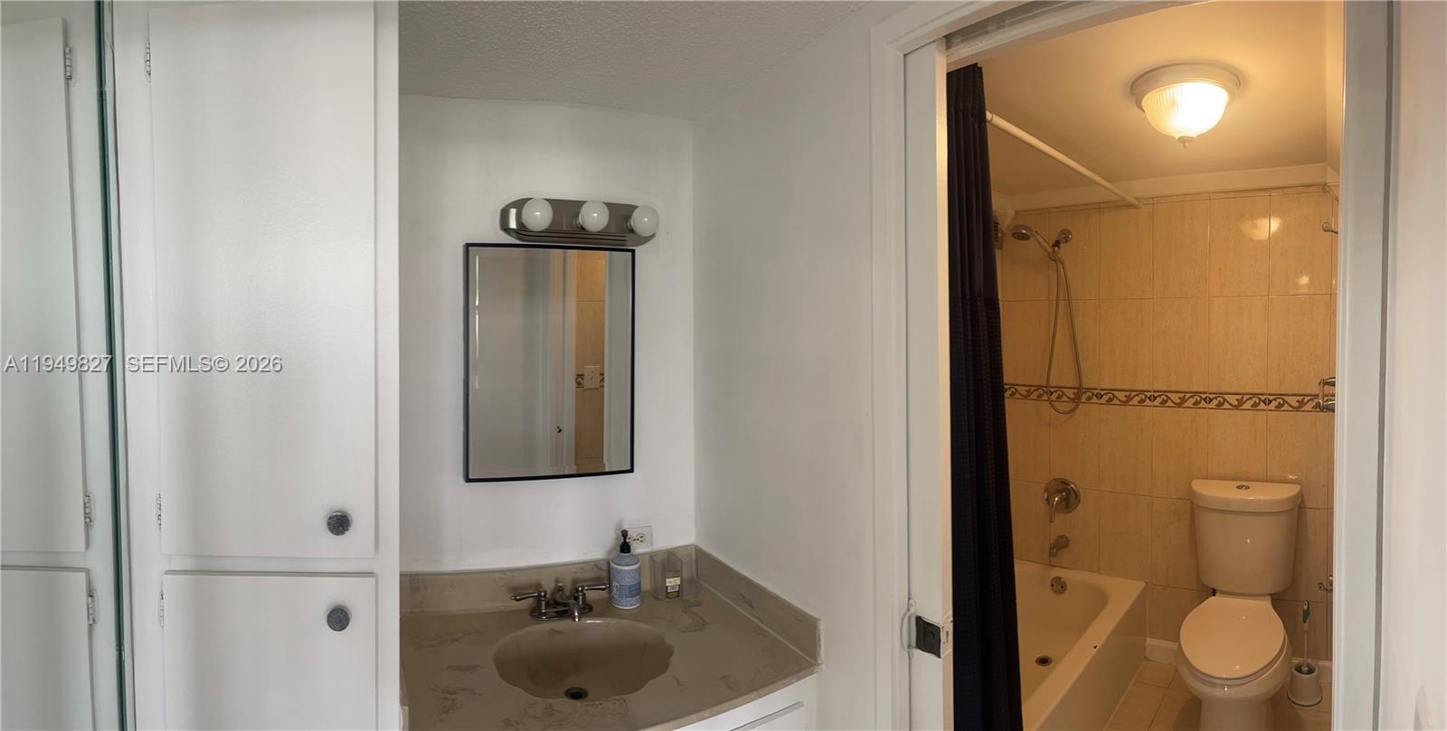 17021 North Bay Road, Unit 603 Sunny Isles Beach, FL 33160 - Photo 7 of 9 a bathroom with a sink and a mirror