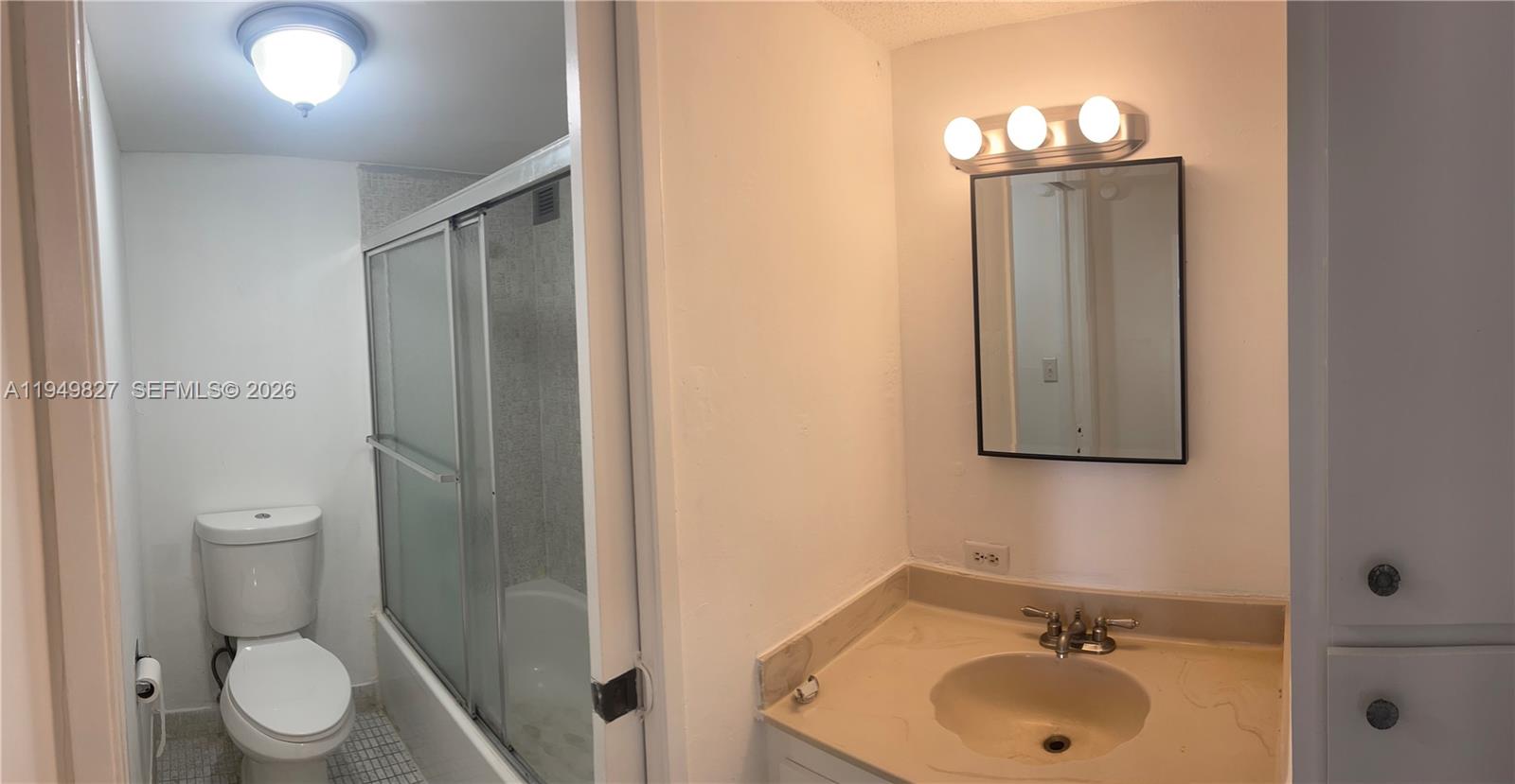17021 North Bay Road, Unit 603 Sunny Isles Beach, FL 33160 - Photo 8 of 9 a bathroom with a toilet sink and mirror