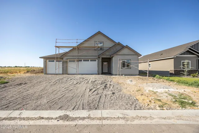 a view of a house with a wooden fence