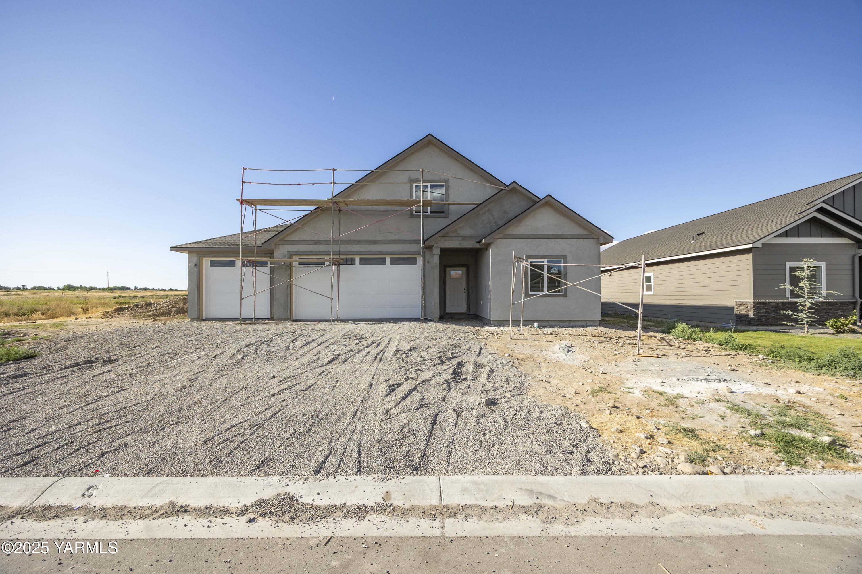 a view of a house with a wooden fence
