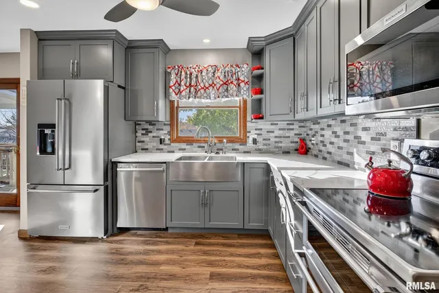 a bedroom with a large bed and a chandelier fan