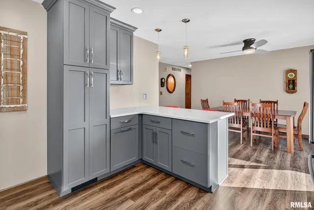 a bathroom with a granite countertop toilet and a sink