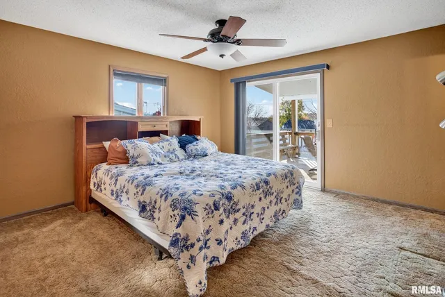 a bathroom with a granite countertop toilet sink and a mirror