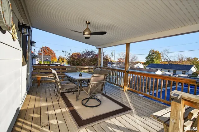 a view of a balcony with furniture and wooden floor