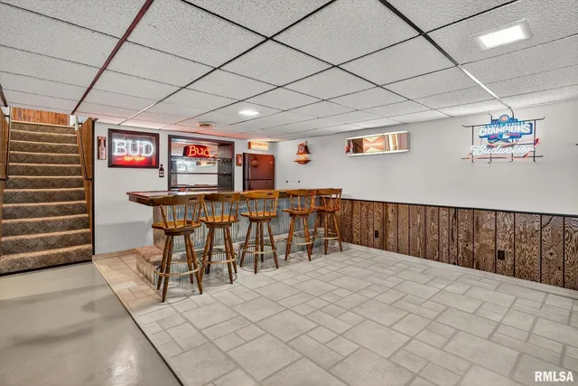 a bathroom with a sink mirror and a toilet